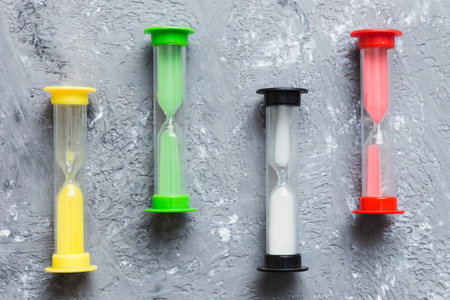 hourglass on the table, sand clock as time passing concept for business deadline.の写真素材