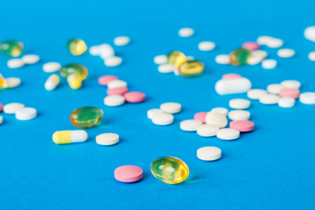Many different colorful medications and pills perspective view. Set of many pills on colored background.の写真素材