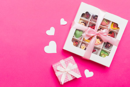 Valentine day composition: sweet candy, with gift boxes with and red felt hearts, photo bow template, background. Top View with copy space.の写真素材
