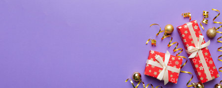 Holiday flat lay with gift boxes wrapped in colorful paper and tied decorated with confetti on colored background. Christmas, Birthday, Valentine and sale concept, top view.の写真素材
