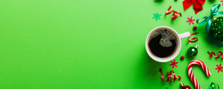 Delicious fresh festive morning coffee in a ceramic cup with little wrapped gifts, ornament and xmas toy. Cup of coffee and new year toys.の写真素材