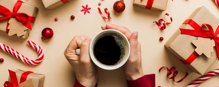 Woman holding cup of coffee. Woman hands holding a mug with hot coffee. Winter and Christmas time concept.の写真素材