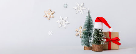 Christmas composition. craft Gift box, small tree, branches and craft DIY decorations on white background. New year concept. Christmas home decoration Flat lay, top view, copy space.の写真素材