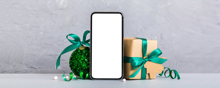 Digital phone mock up with rustic Christmas decorations for app presentation with empty space for...
