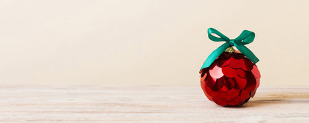 Christmas ball on colored background. decoration bauble with ribbon bow with copy space.の写真素材