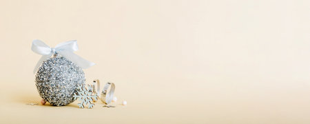 Christmas ball on colored background. decoration bauble with ribbon bow with copy space.の写真素材