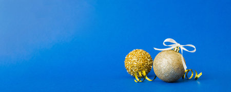 Christmas ball on colored background. decoration bauble with ribbon bow with copy space.