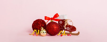 Christmas ball with skates on colored background. decoration bauble with ribbon bow with copy space.
