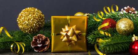 New Year Christmas mood, gift box, branches of a Christmas tree, New Year decorations on a colored...
