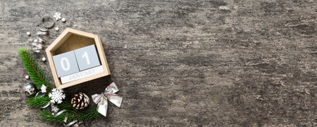 Christmas calendar 1 January. Christmas gift, fir branches, pine cones. Flat lay, top view. New Year decorations on a colored background.の写真素材