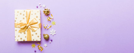 Top view Flat lay Christmas decorations and gift box on colored background with copy space. Christmas or Happy New Year composition.の写真素材