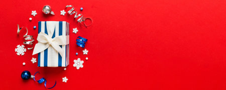 Top view Flat lay Christmas decorations and gift box on colored background with copy space. Christmas or Happy New Year composition.の写真素材