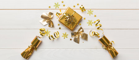 Christmas crackers with shiny confetti on color background, top view, copy space.の写真素材