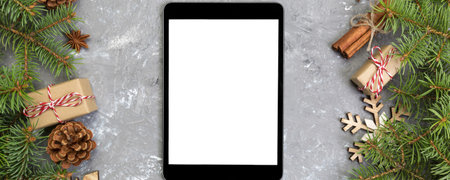 Digital mock up tablet up with rustic Christmas gray cement background decorations for app...