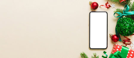 Digital phone mock up with rustic Christmas decorations for app presentation top view with empty...