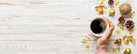 Woman holding cup of coffee. Woman hands holding a mug with hot coffee. Winter and Christmas time...