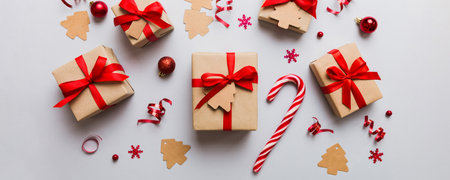 Christmas kraft gifts box with ribbon on colored background. Cozy Christmas still life, birthday or...