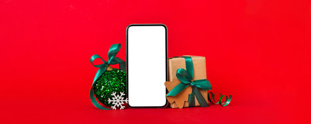Digital phone mock up with rustic Christmas decorations for app presentation with empty space for you design. Christmas online shopping concept. Tablet with copy space on colored background.の写真素材