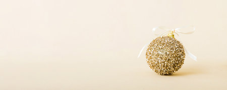 Christmas ball on colored background. decoration bauble with ribbon bow with copy space.の写真素材