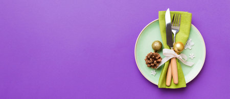 Christmas table place setting with christmas decor and plates, fork and spoon. Christmas holiday background. Top view with copy space.の写真素材