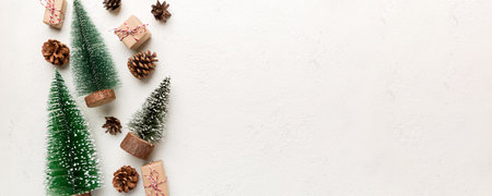 Flat lay composition with christmas trees on color background. Top view with copy space.
