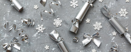 Christmas crackers with shiny confetti on color background, top view, copy space.の写真素材