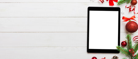 Digital tablet mock up with rustic Christmas decorations for app presentation top view with empty...
