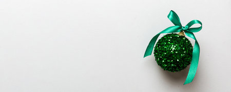 Christmas ball on colored background. decoration bauble with ribbon bow with copy space.の写真素材