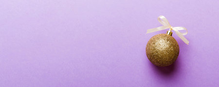 Christmas ball on colored background. decoration bauble with ribbon bow with copy space.の写真素材