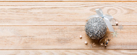 Christmas ball on colored background. decoration bauble with ribbon bow with copy space.の写真素材