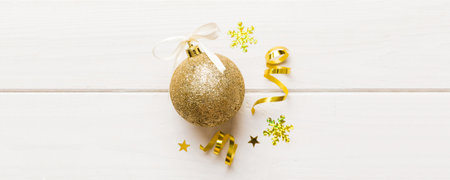 Christmas ball on colored background. decoration bauble with ribbon bow with copy space.の写真素材