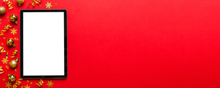 Christmas online shopping from home tablet pc with blank white display top view. Tablet with copy...