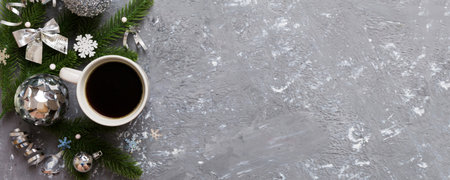 Delicious fresh festive morning coffee in a ceramic cup with little wrapped gifts, ornament and xmas...
