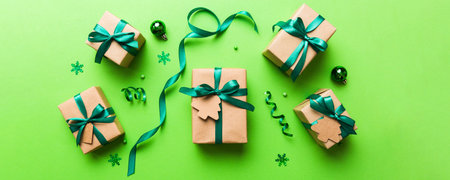Christmas kraft gifts box with ribbon on colored background. Cozy Christmas still life, birthday or new year.の写真素材