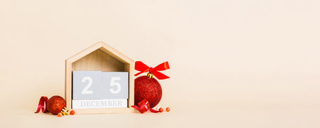 25 december. Christmas composition on colored background with a wooden calendar, with a gift box,...