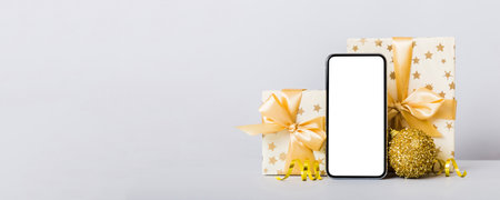 Digital phone mock up with rustic Christmas decorations for app presentation with empty space for you design. Christmas online shopping concept. Tablet with copy space on colored background.の写真素材