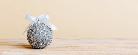 Christmas ball on colored background. decoration bauble with ribbon bow with copy space.の写真素材