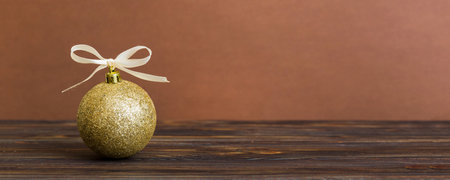 Christmas ball on colored background. decoration bauble with ribbon bow with copy space.