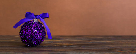 Christmas ball on colored background. decoration bauble with ribbon bow with copy space.の写真素材