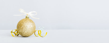 Christmas ball on colored background. decoration bauble with ribbon bow with copy space.の写真素材
