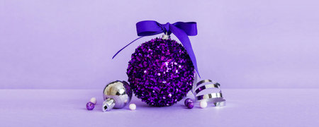 Christmas ball on colored background. decoration bauble with ribbon bow with copy space.の写真素材