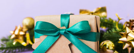 New Year Christmas mood, gift box, branches of a Christmas tree, New Year decorations on a colored...