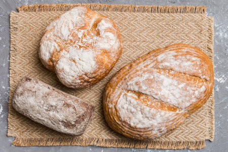Assortment of freshly baked bread with napkin on rustic table top view. Healthy unleavened bread....