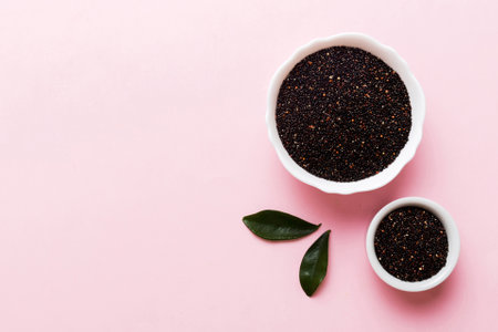 quinoa seeds in bowl on colored background. Healthy kinwa in small bowl. Healthy superfood.の写真素材