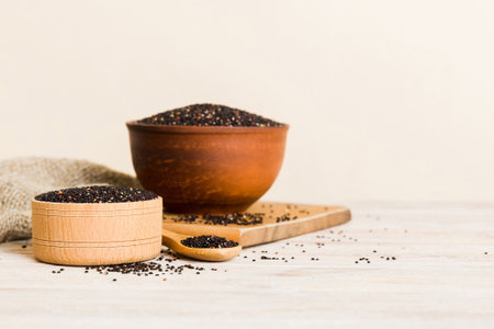 quinoa seeds in bowl and spoon on colored background. Healthy superfood.の写真素材