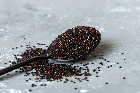 quinoa seeds in spoon on colored background. Healthy superfood.の写真素材
