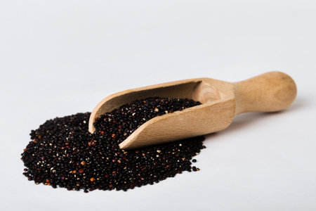 quinoa seeds in spoon on colored background. Healthy superfood.の写真素材