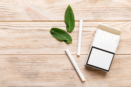 Menthol cigarettes and fresh mint on colored table, Menthol cigarettes top view flat lay.の写真素材