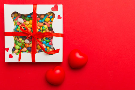 Valentine day composition: sweet candy, with gift boxes with and red felt hearts, photo bow template, background. Top View with copy space.の写真素材