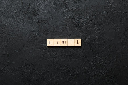 limit written word on wood block. limit text on table, concept.の写真素材
